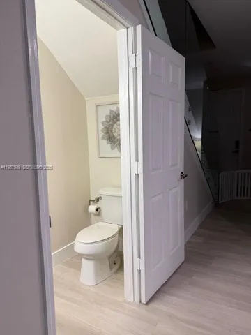 a bathroom with a toilet sink and a mirror