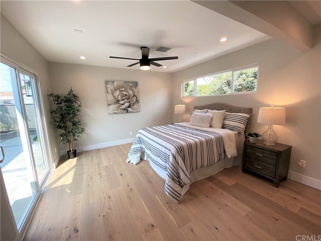 5035 Avenue B Torrance, CA 90505 - Photo 35 of 60 a bedroom with a large bed and a chandelier
