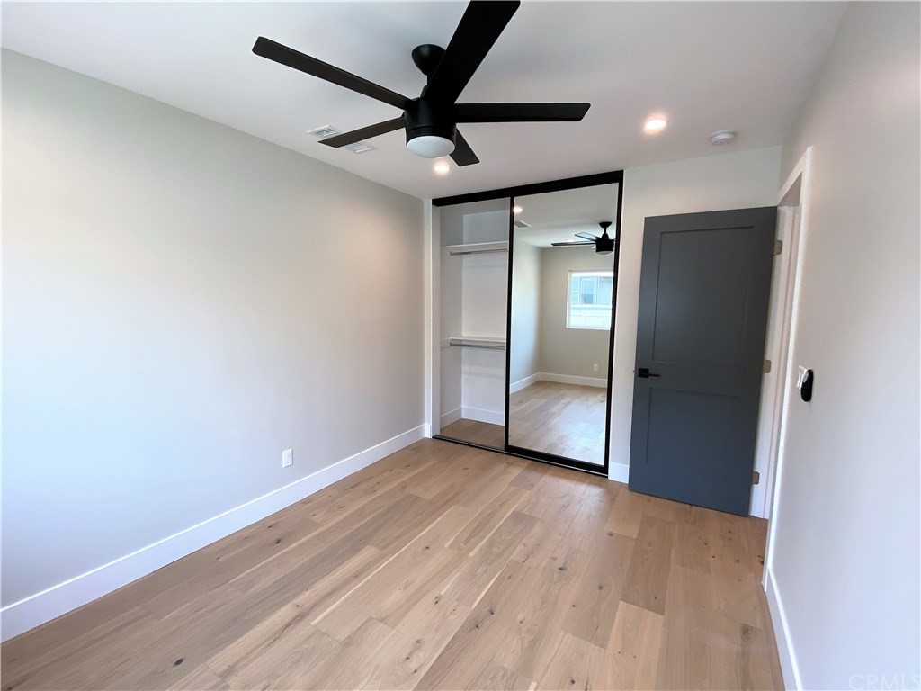 5035 Avenue B Torrance, CA 90505 - Photo 42 of 60 an empty room with wooden floor and a ceiling fan