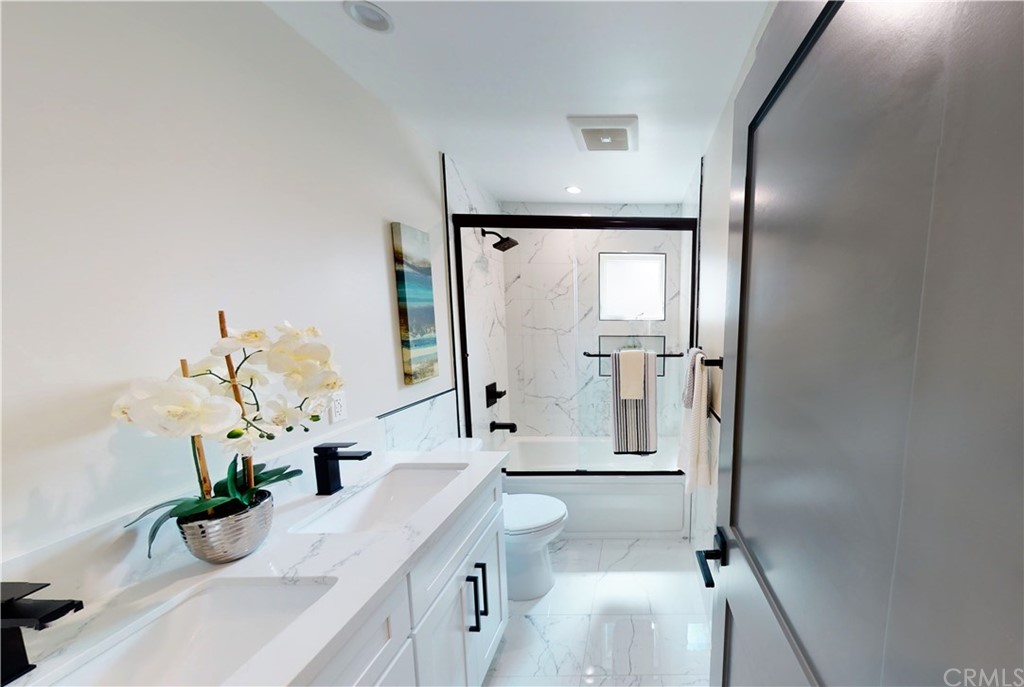 5035 Avenue B Torrance, CA 90505 - Photo 45 of 60 a bathroom with a sink a mirror and a shower