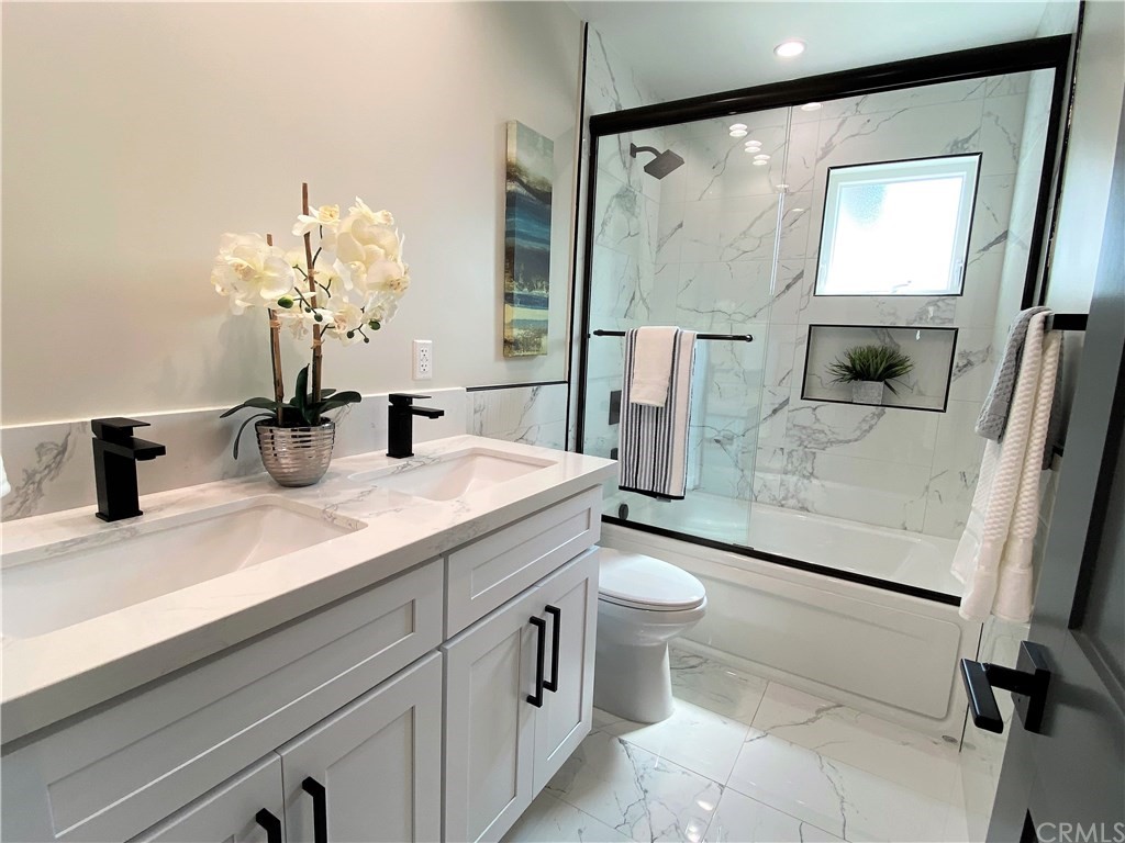 5035 Avenue B Torrance, CA 90505 - Photo 47 of 60 a bathroom with a double vanity sink toilet and mirror