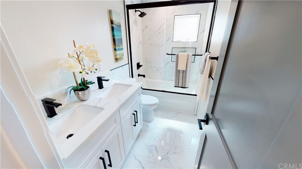 5035 Avenue B Torrance, CA 90505 - Photo 48 of 60 a bathroom with a sink a toilet a mirror and vanity