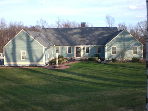 948 Cronin Road Warren, MA 01585 - Photo 1 of 25 a view of a house with a big yard and sitting area