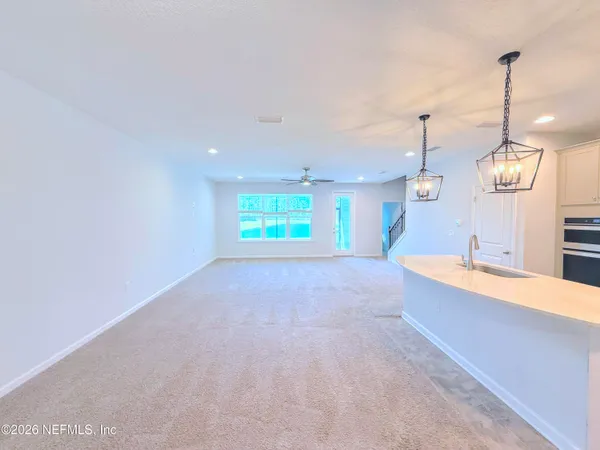 a kitchen with stainless steel appliances a stove a sink and cabinets
