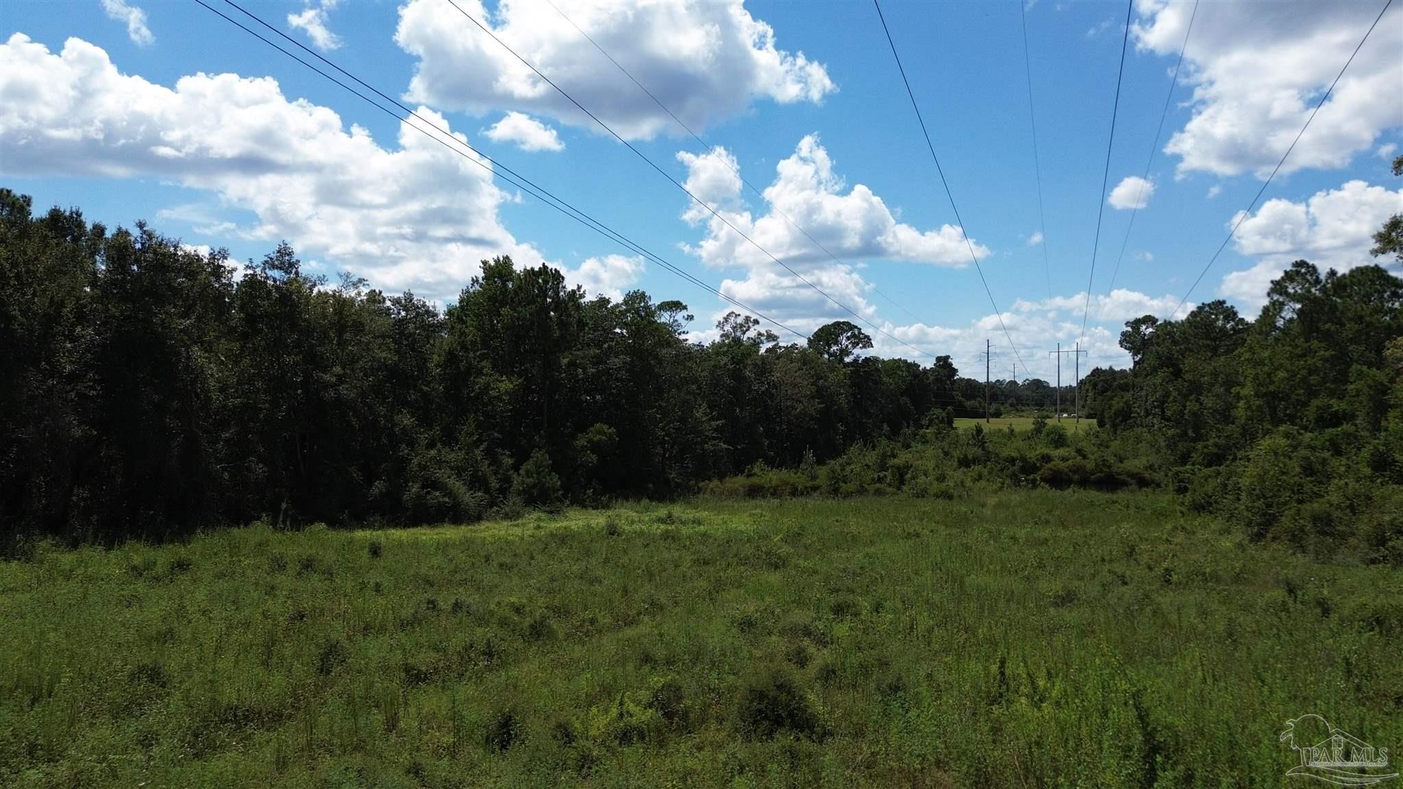 1 Chumuckla Highway Pace, FL 32571 - Photo 3 of 8 a view of a city with lush green forest
