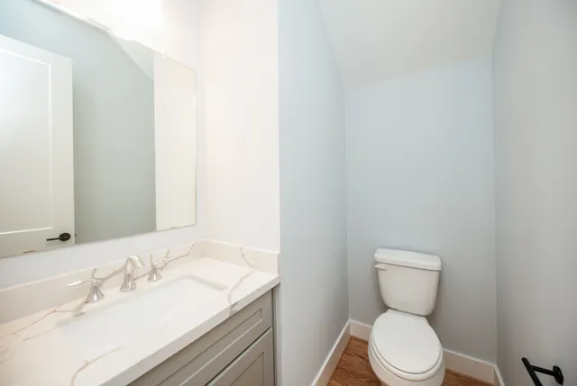 a view of a kitchen with kitchen island a sink stainless steel appliances and cabinets