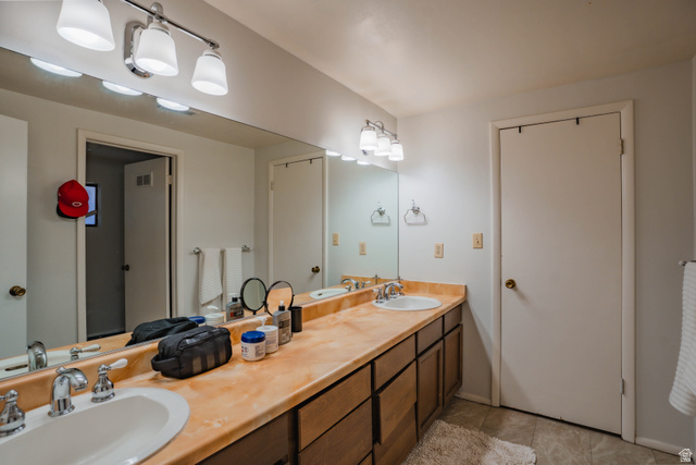 980 Cactus Circle St. George, UT 84790 - Photo 36 of 77 Bathroom with double vanity and light tile patterned floors