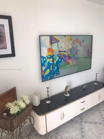 a living room with furniture and wall painting