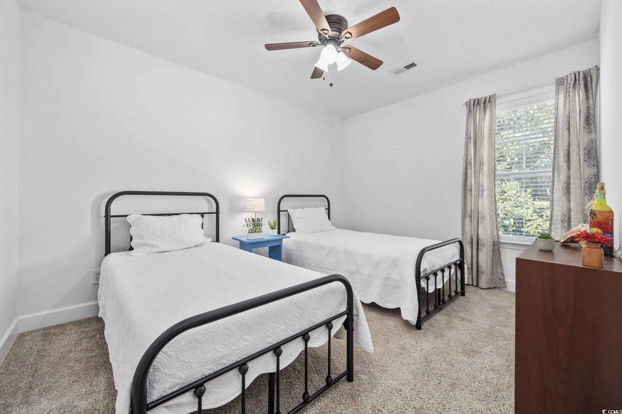 306 River Rock Lane, Unit 1304 Murrells Inlet, SC 29576 - Photo 27 of 40 Bedroom with light carpet and ceiling fan