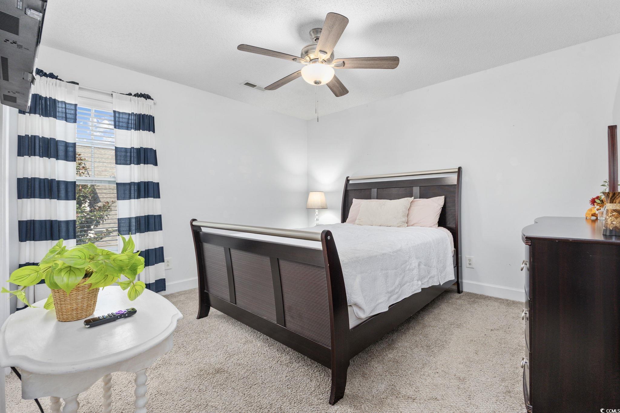 306 River Rock Lane, Unit 1304 Murrells Inlet, SC 29576 - Photo 30 of 40 Carpeted bedroom featuring a ceiling fan and baseboards