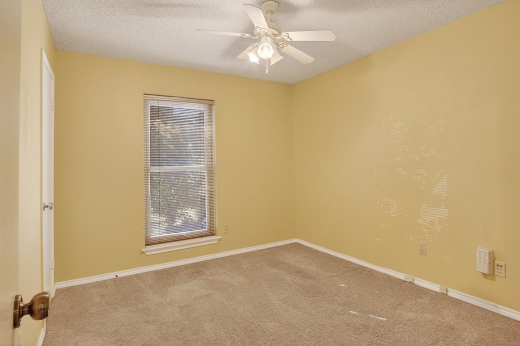 6946 Trailcrest Drive Dallas, TX 75232 - Photo 17 of 22 an empty room with windows and fan