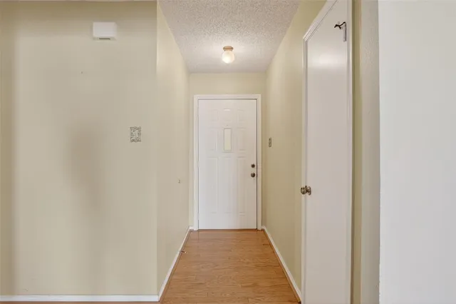 a view of a hallway with a white door
