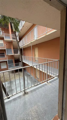 a view of staircase with white walls and a window