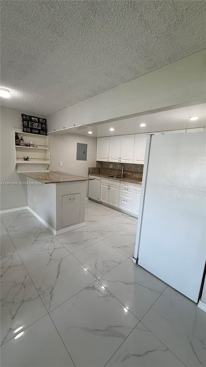 17600 Northwest 68th Avenue, Unit B2002 Hialeah, FL 33015 - Photo 17 of 38 a large white kitchen with white cabinets and a stainless steel appliances
