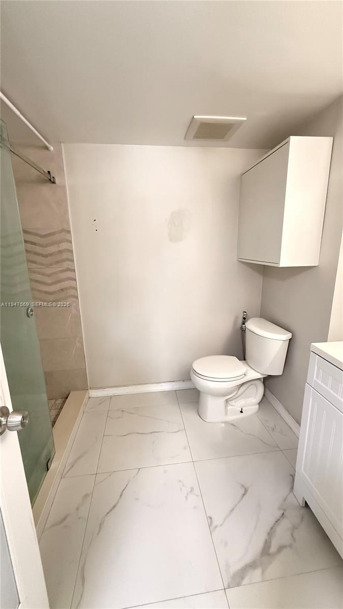 17600 Northwest 68th Avenue, Unit B2002 Hialeah, FL 33015 - Photo 19 of 38 a bathroom with a toilet and a shower