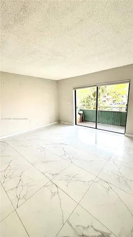 an empty room with floor to ceiling window