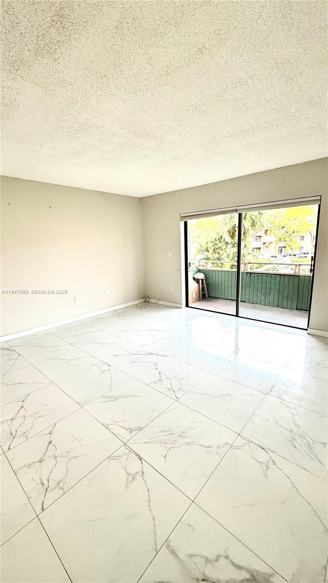 17600 Northwest 68th Avenue, Unit B2002 Hialeah, FL 33015 - Photo 21 of 38 a view of an empty room and a window