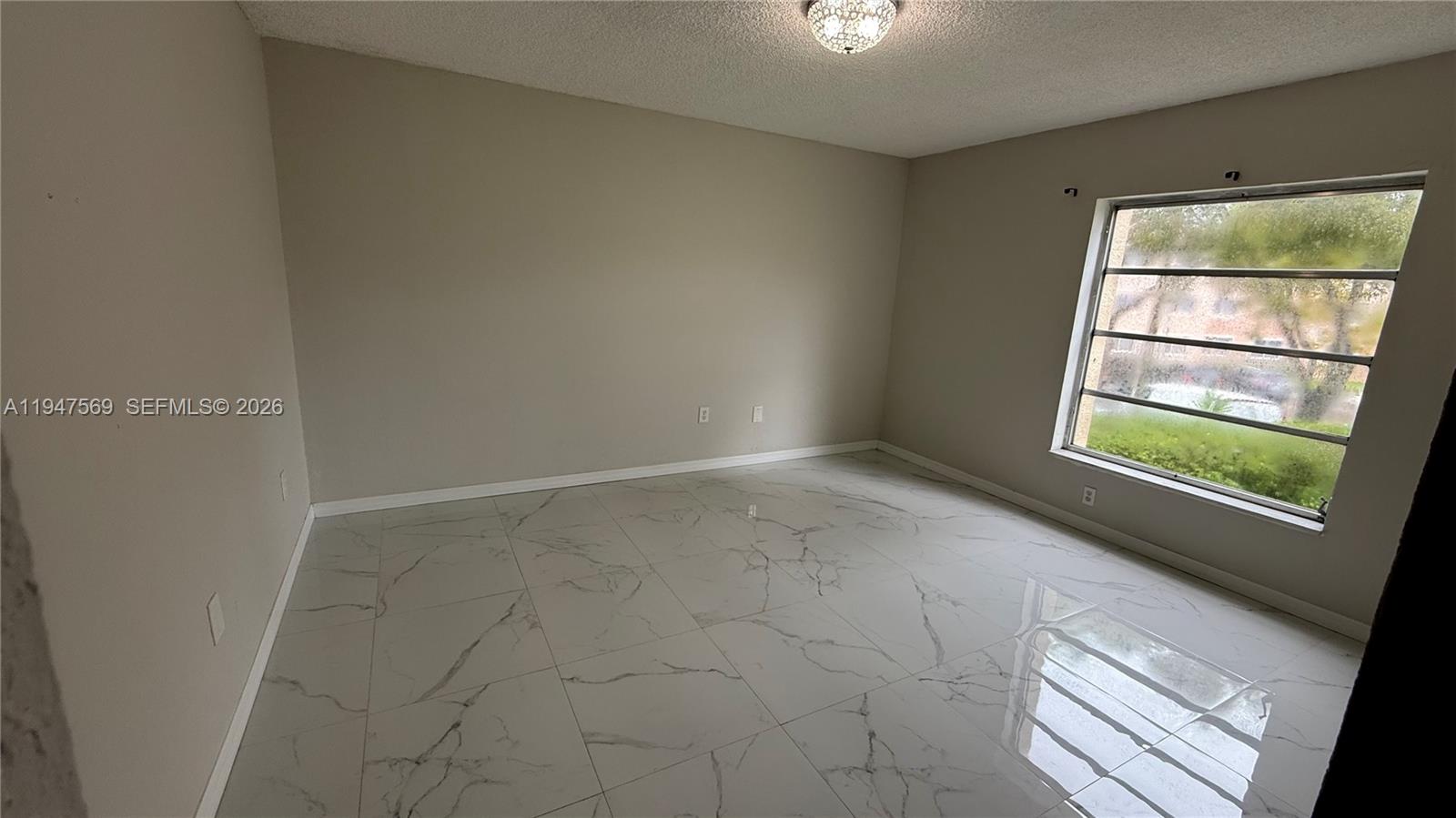 17600 Northwest 68th Avenue, Unit B2002 Hialeah, FL 33015 - Photo 30 of 38 an empty room with windows and closet