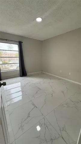 a bathroom with a granite countertop sink a mirror and a