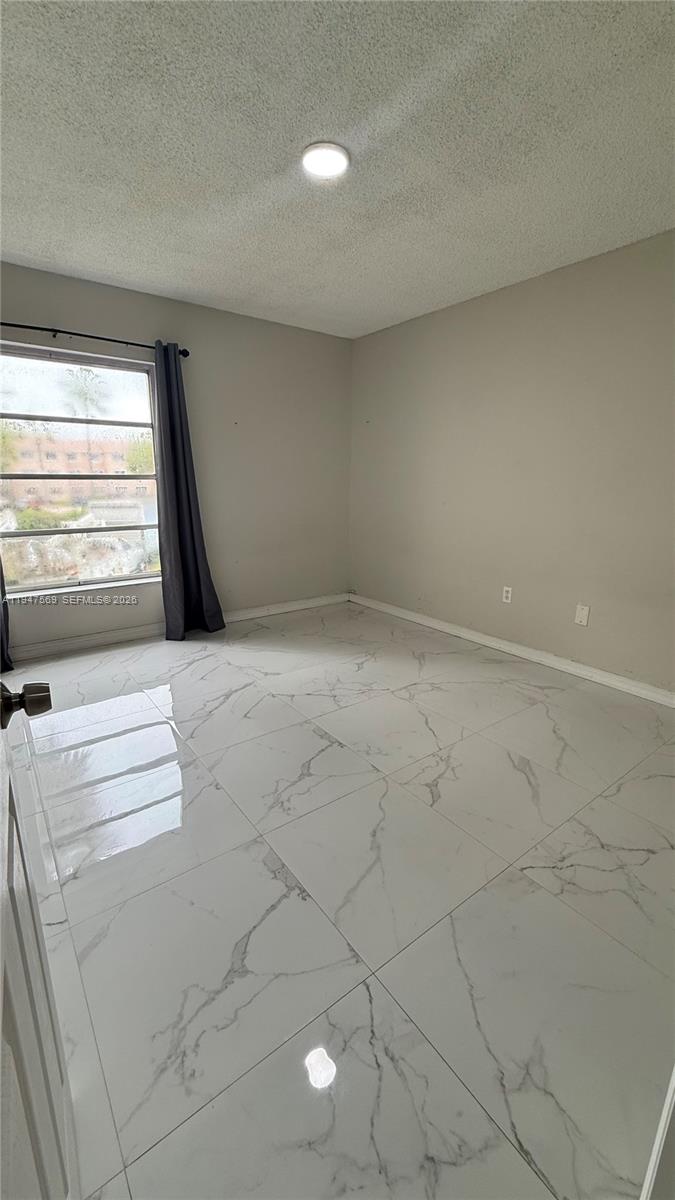 17600 Northwest 68th Avenue, Unit B2002 Hialeah, FL 33015 - Photo 32 of 38 a view of an empty room with a window
