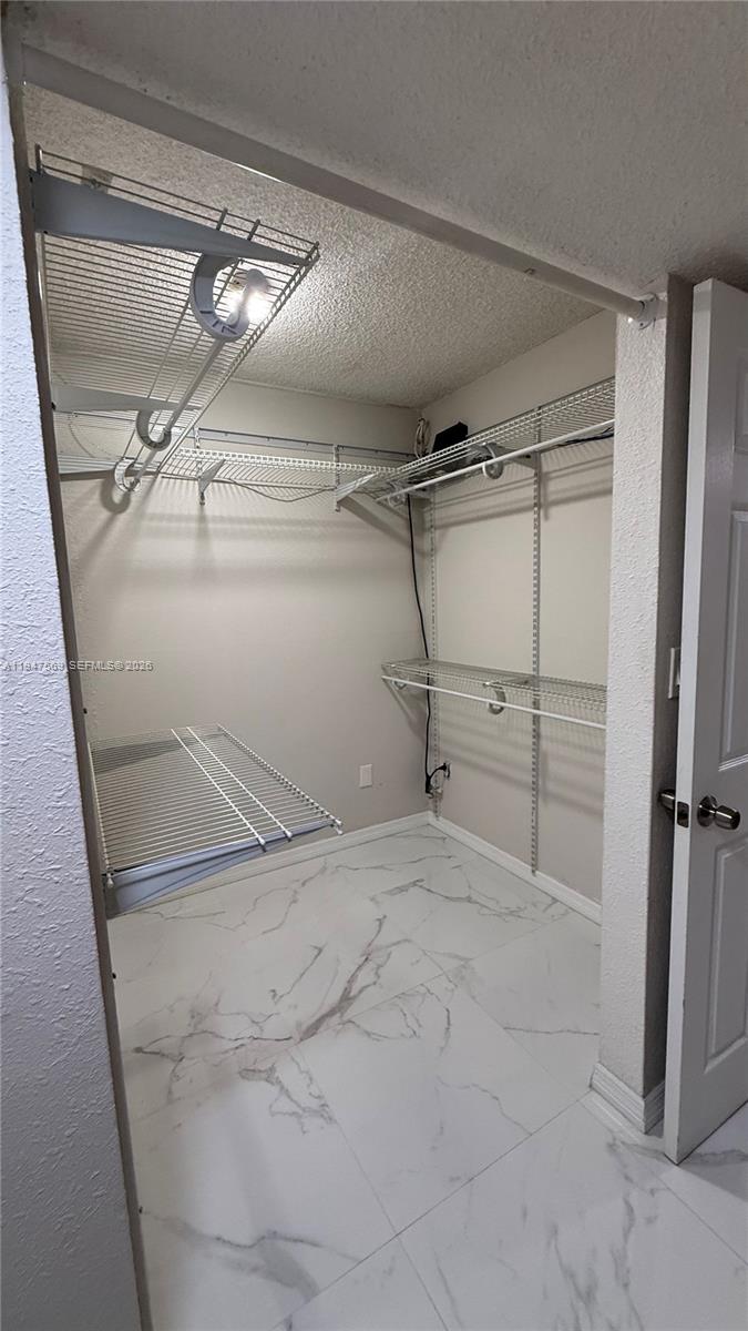 17600 Northwest 68th Avenue, Unit B2002 Hialeah, FL 33015 - Photo 34 of 38 a view of a room with racks on the wall