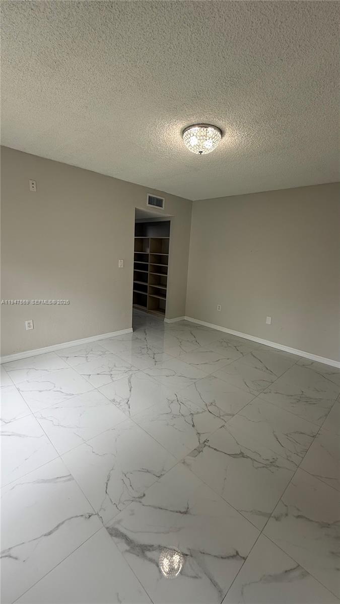 17600 Northwest 68th Avenue, Unit B2002 Hialeah, FL 33015 - Photo 37 of 38 an empty room with windows