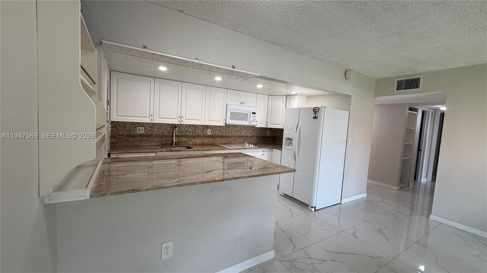 17600 Northwest 68th Avenue, Unit B2002 Hialeah, FL 33015 - Photo 9 of 38 a kitchen with stainless steel appliances granite countertop a refrigerator and a sink