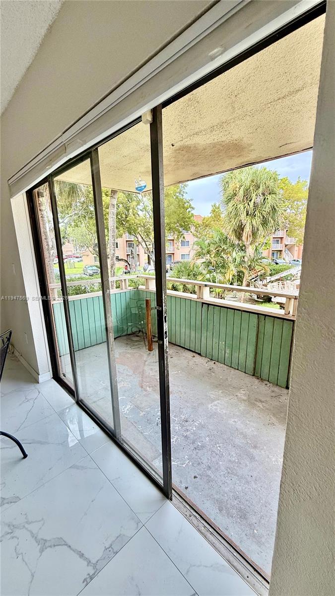 17600 Northwest 68th Avenue, Unit B2002 Hialeah, FL 33015 - Photo 10 of 38 a view of hallway with window