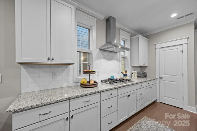 a kitchen with white cabinets and a sink