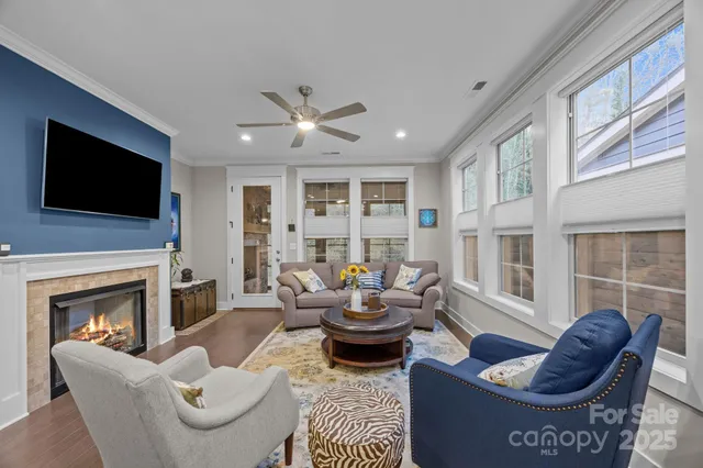 a living room with furniture a fireplace and a flat screen tv