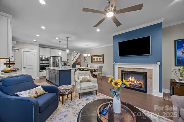 a living room with furniture a fireplace and a flat screen tv