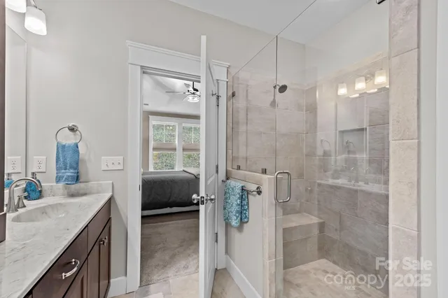 a en suite bathroom with a granite countertop sink a toilet and shower
