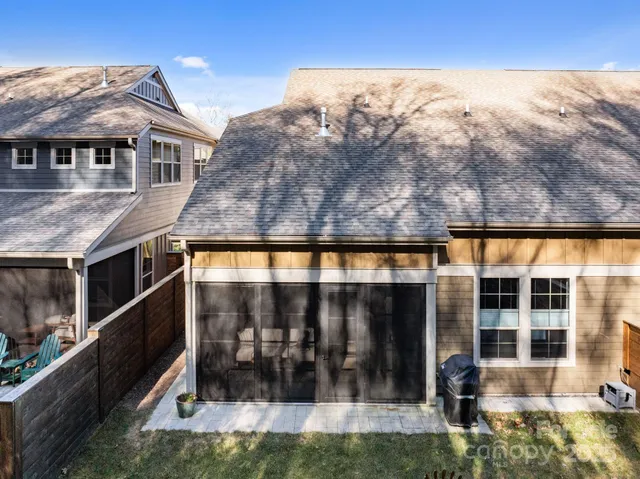 a front view of a house with glass windows and a yard