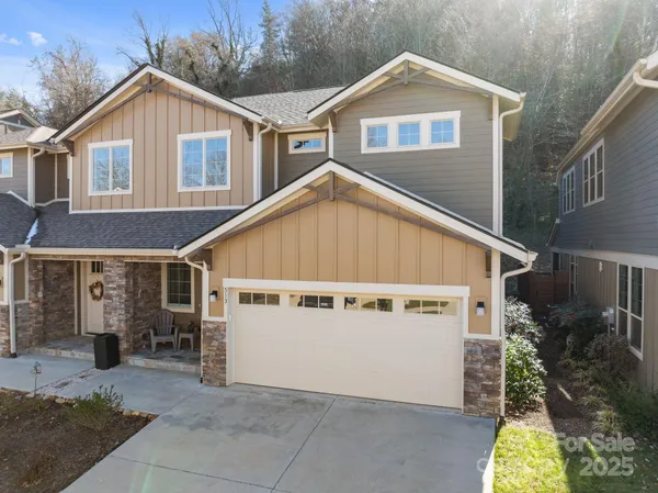 a view of a house with garage and yard
