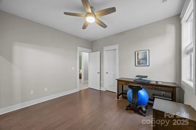a view of a workspace with furniture and a window