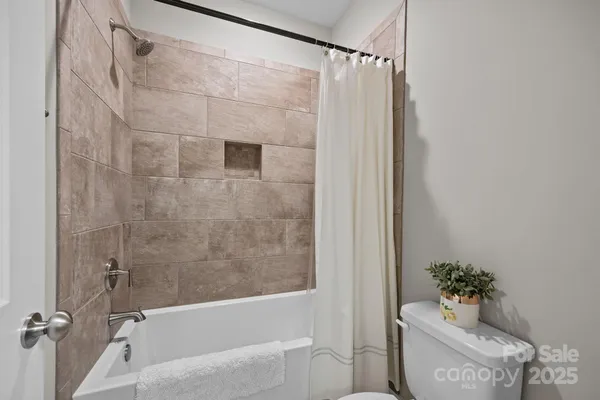 a bathroom with a shower and a toilet