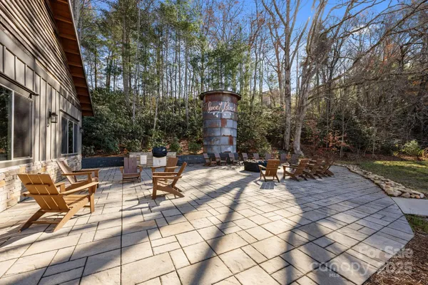 a view of backyard with swimming pool and sitting area