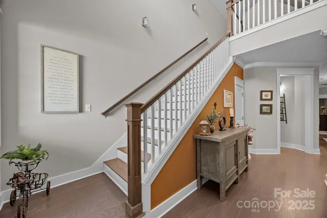 a view of entryway with wooden floor and stairs