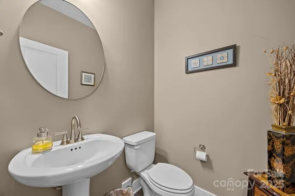 a bathroom with a sink mirror and toilet