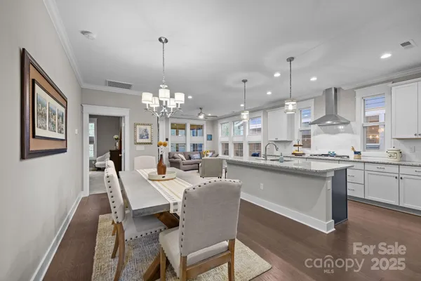 a large kitchen with a table and chairs