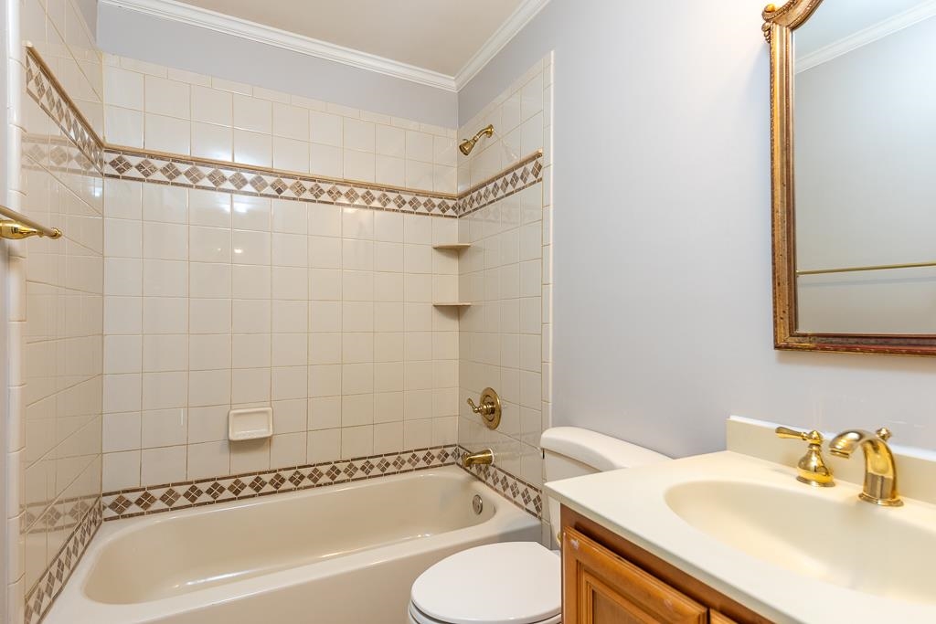 1806 Kimbrough Road Germantown, TN 38138 - Photo 22 of 26 a bathroom with a sink a mirror and a bathtub