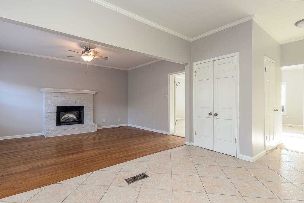 1806 Kimbrough Road Germantown, TN 38138 - Photo 9 of 26 a view of an empty room with a chandelier fan and a fireplace