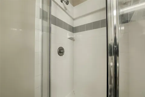 a bathroom with a shower and a mirror
