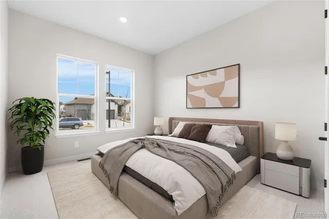 a bedroom with a bed and a couch