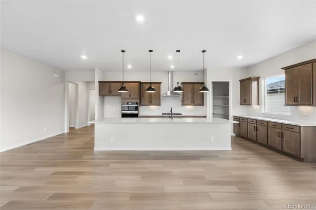 a view living room with stainless steel appliances kitchen island sink and living room view