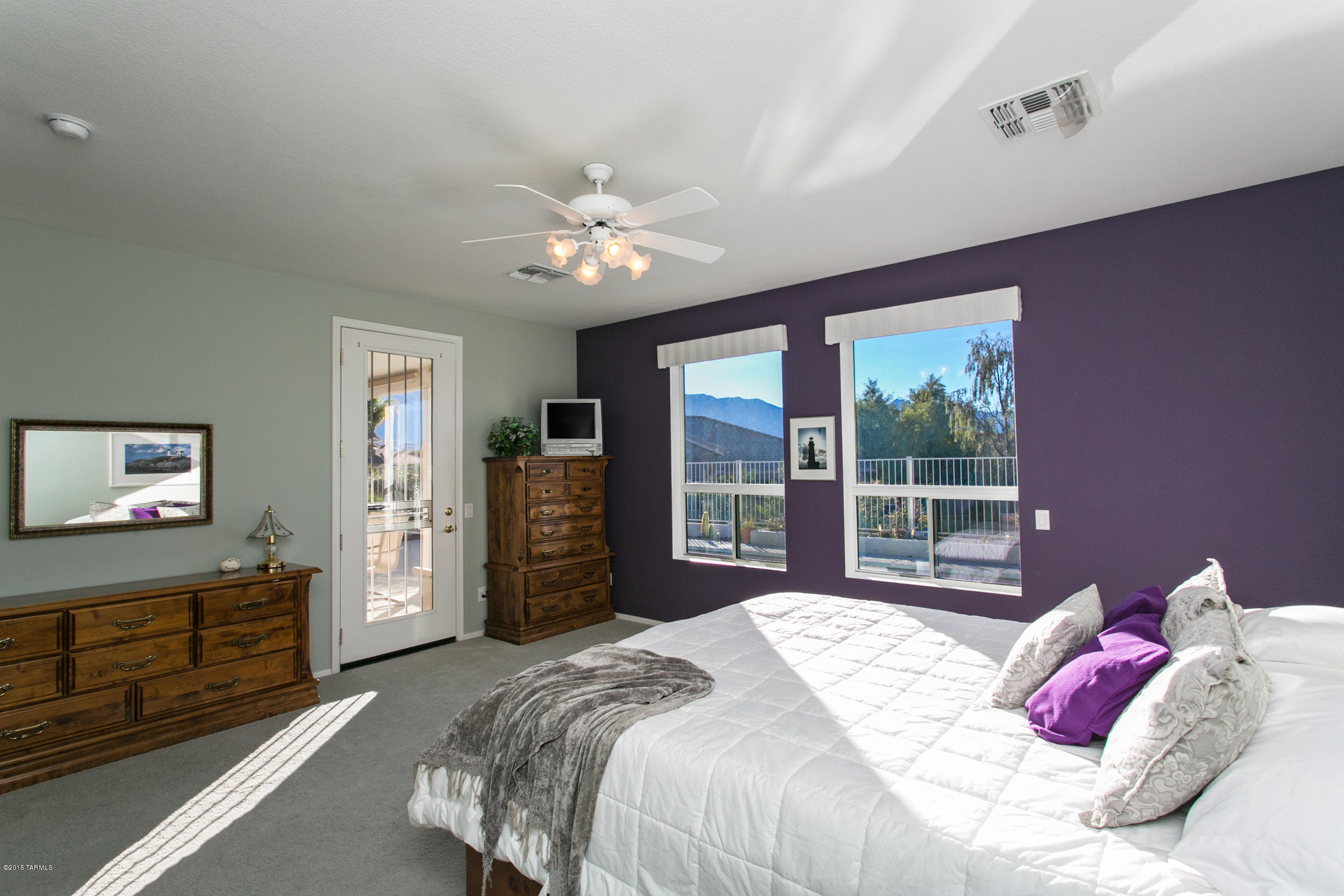 62419 East Northwood Road Tucson, AZ 85739 - Photo 3 of 30 a bedroom with a large bed and a window