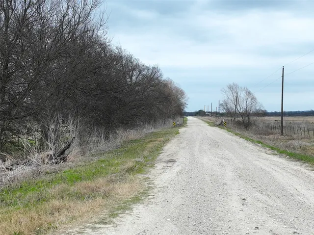 a view of a yard with wooden fence