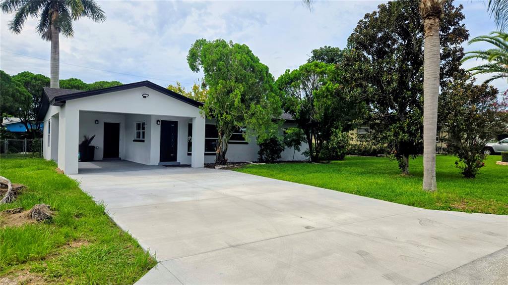 115 15th Avenue Southwest Largo, FL 33770 - Photo 13 of 13 a view of a house with a yard and palm trees