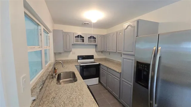 a kitchen with a refrigerator stove and sink