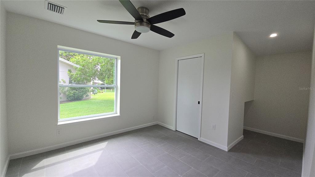 115 15th Avenue Southwest Largo, FL 33770 - Photo 5 of 13 a view of a livingroom with a ceiling fan and a window